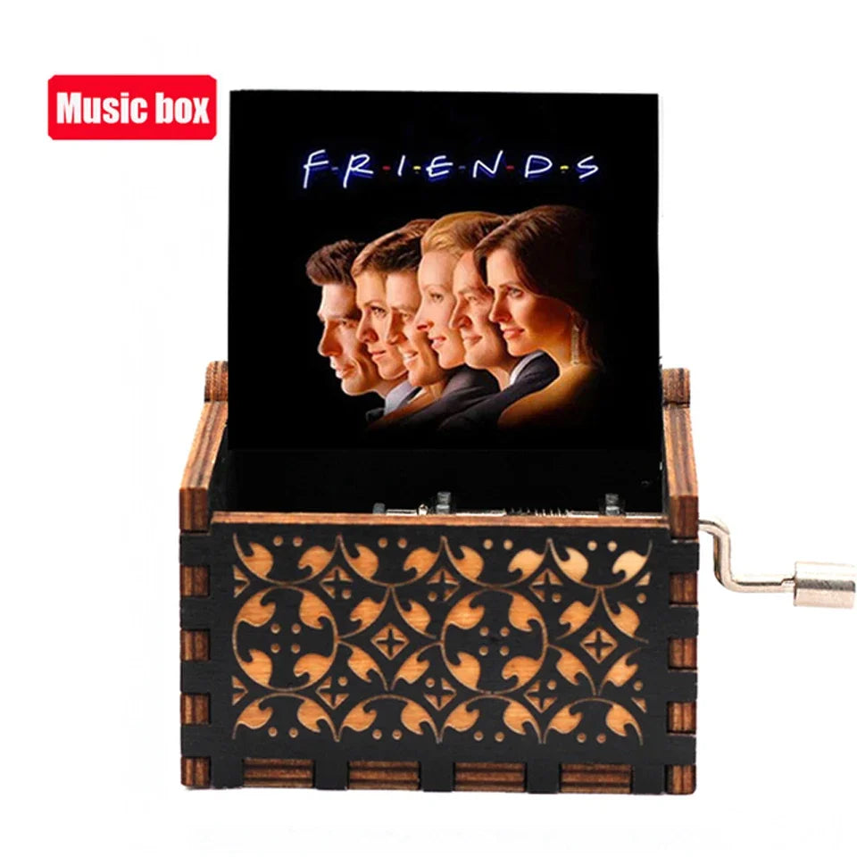 A carved wooden music box featuring a display of friends silhouettes on a dark background.