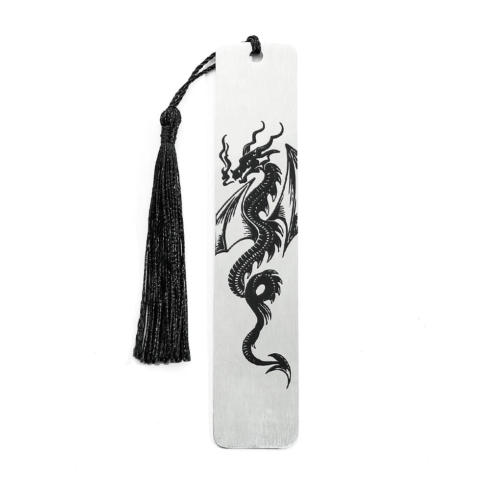 A silver metal dragon design on a white bookmark with a black tassel.