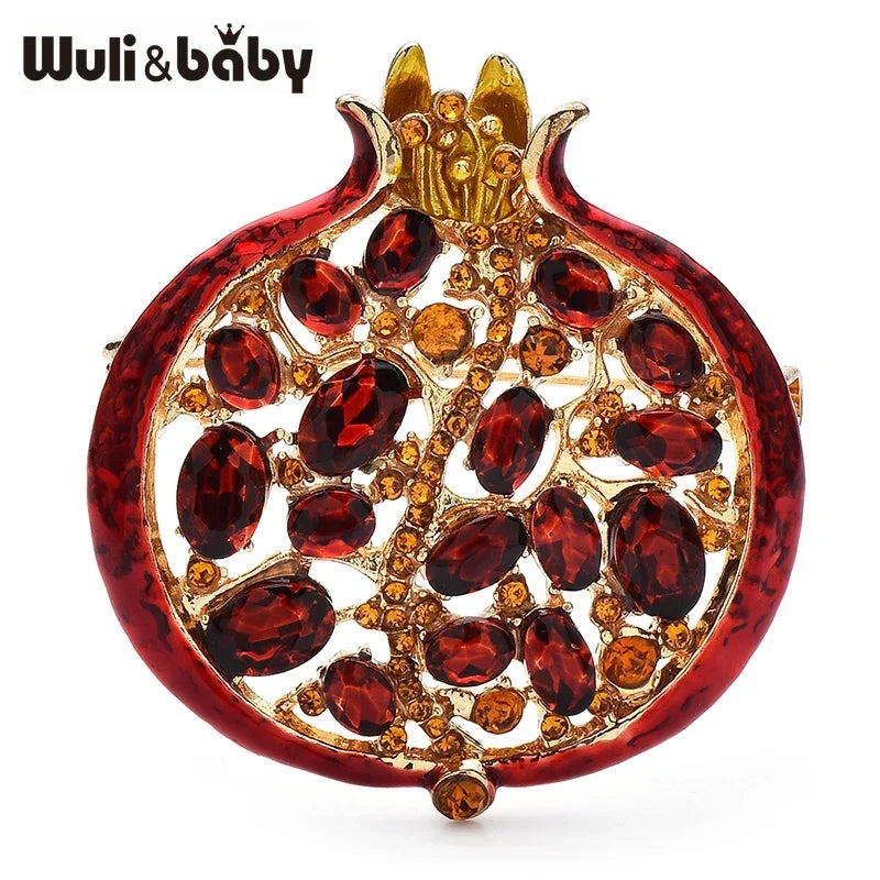 A detailed crystal pomegranate brooch pin featuring a red gemstone design.
