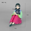 A collectible PVC figure of Maomao from The Apothecary Diaries, featuring dark hair and a green and blue outfit.