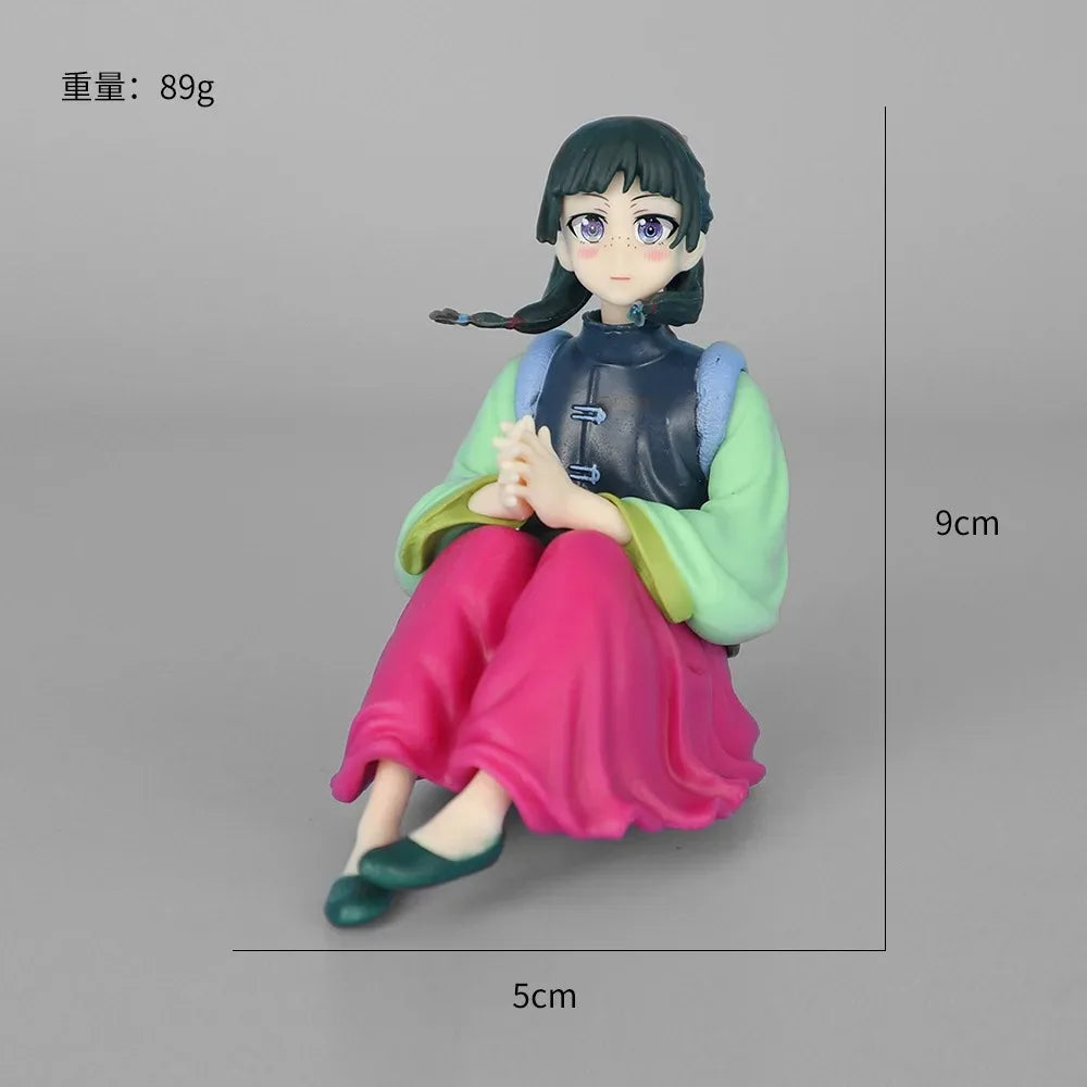 A collectible PVC figure of Maomao from The Apothecary Diaries, featuring dark hair and a green and blue outfit.