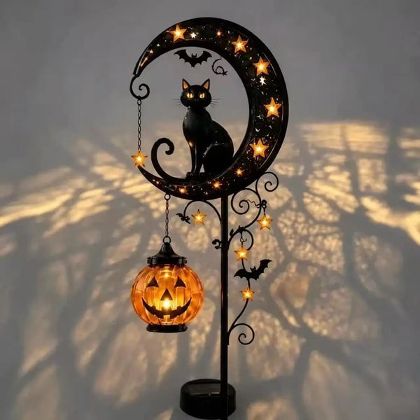 A black cat silhouette and pumpkin moon design on a stake light with glowing elements.