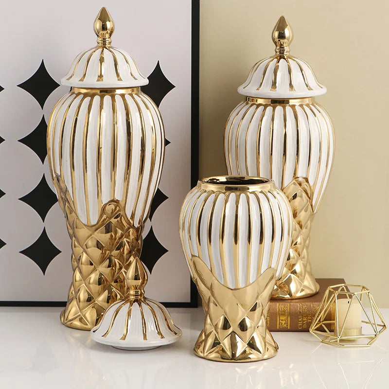 A set of handcrafted ceramic decorative vases in gold and white with ribbed textures.