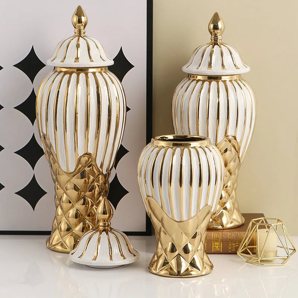 A set of handcrafted ceramic decorative vases in gold and white with ribbed textures.
