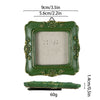 A vintage baroque resin picture frame in olive green with gold accents, shown with a separate backing piece.