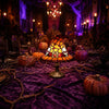 A glowing orange and yellow witch hat night light with a stained glass effect sits on a purple fabric surrounded by pumpkins 