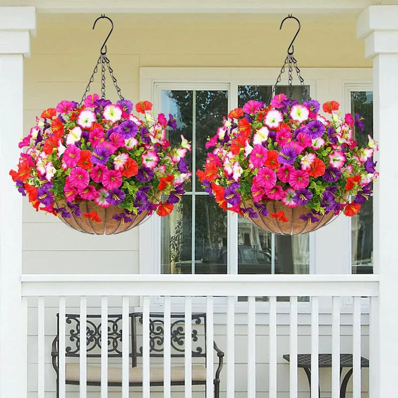 A hanging basket filled with vibrant artificial silk cloth flowers in shades of pink, purple, and red, displayed on a porch r