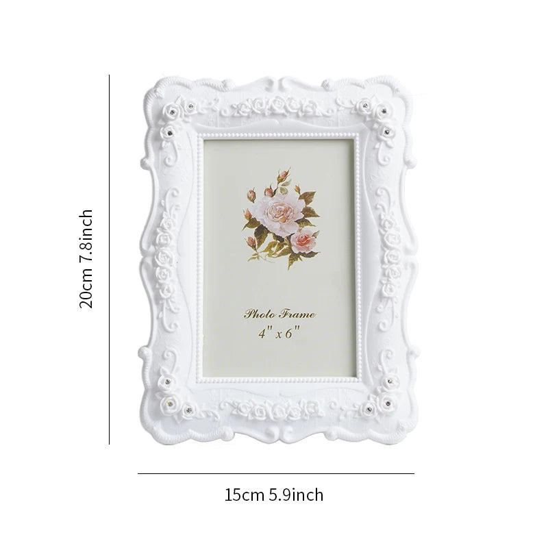 White ornate photo frame with a distressed border and a pink rose floral design inside
