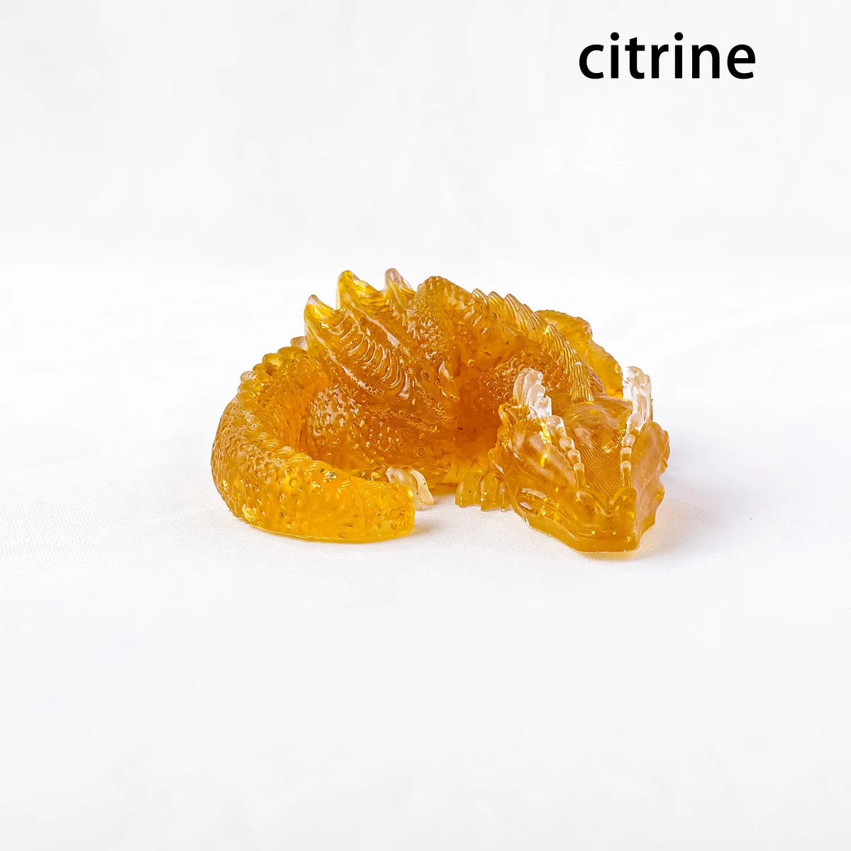 A translucent yellow citrine crystal figurine shaped like a dragon for Feng Shui decor.