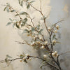 A painting of a bare branch with small white blossoms against a muted gray background.