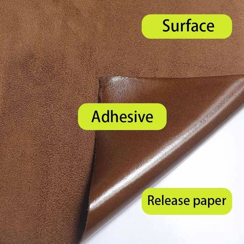 Close-up view of brown suede wrap fabric showing an adhesive layer and release paper for DIY projects.