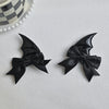A pair of black devil horn and bat wing hair clips set