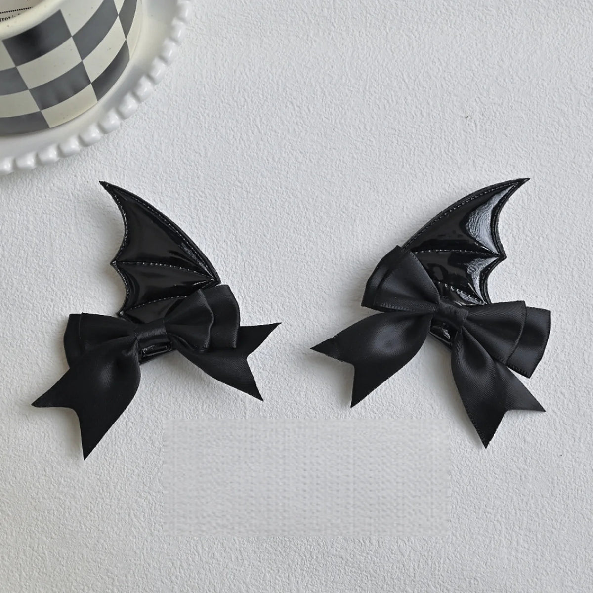 A pair of black devil horn and bat wing hair clips set