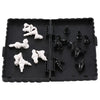 A black portable folding magnetic chess set with white pieces and a board.