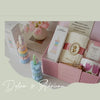 A pink box containing handcrafted soy wax aromatherapy candles and floral decor for weddings and home décor.
