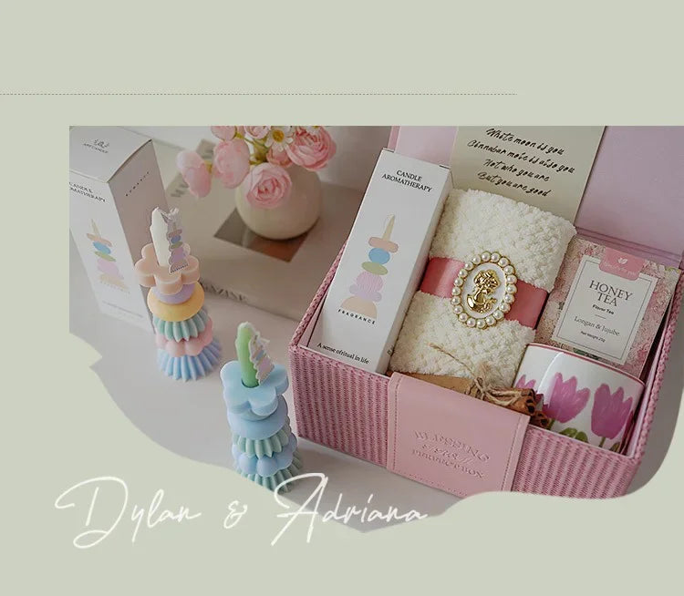 A pink box containing handcrafted soy wax aromatherapy candles and floral decor for weddings and home décor.
