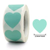 A roll of heart-shaped seal stickers in teal and white for crafting and packaging.