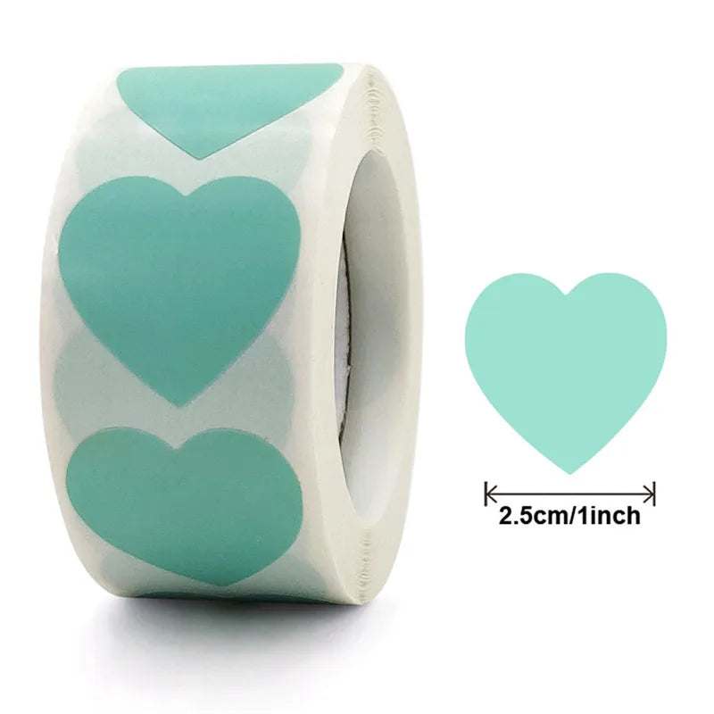 A roll of heart-shaped seal stickers in teal and white for crafting and packaging.