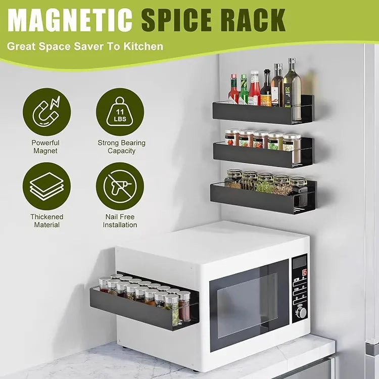 A magnetic spice rack with multiple tiers is mounted on a white cabinet, showing various bottles of spices and oils.