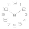 A modern 3D acrylic wall clock face showing the numbers 1 through 12 and a central hand.