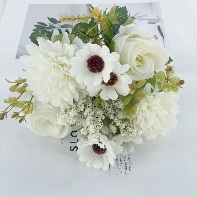 A bouquet of artificial white roses, daisies, and chrysanthemums arranged on a white background.