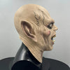 A realistic demon latex mask with sharp teeth displayed on a black mannequin head.