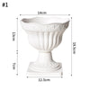 White plastic decorative vase with a flared bowl and pedestal base.