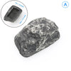 A dark gray, rough-textured garden key hiding stone with a rectangular depression for keys.