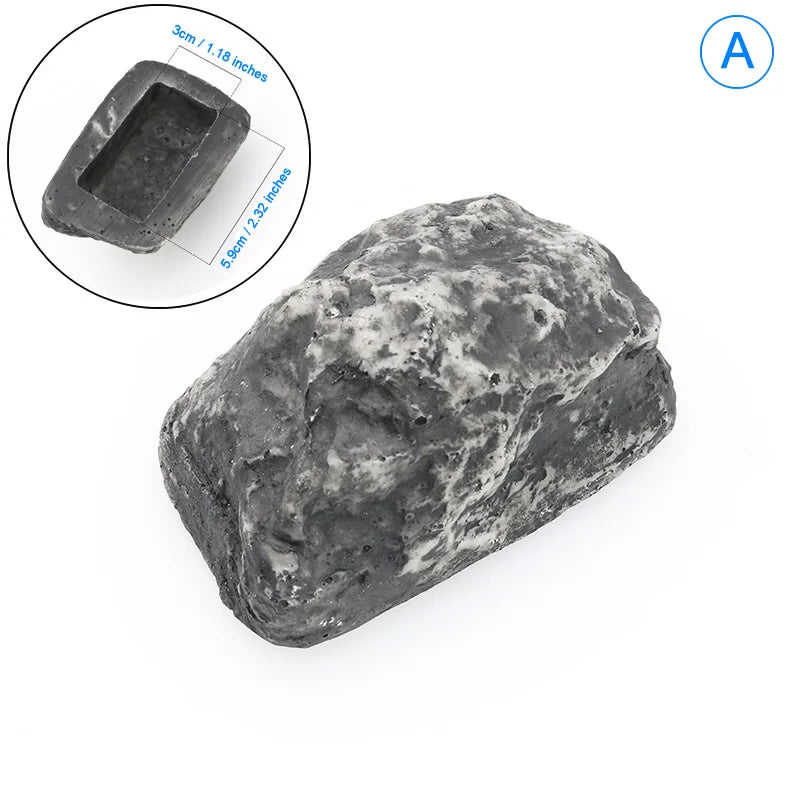 A dark gray, rough-textured garden key hiding stone with a rectangular depression for keys.