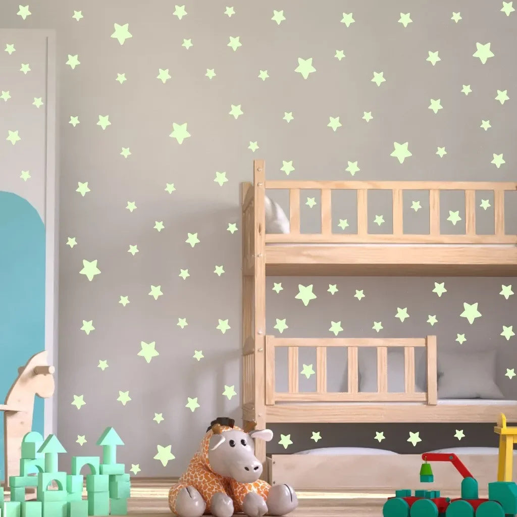 A wooden crib with light green star wall decals and a stuffed animal in a nursery setting.