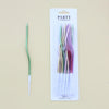 A set of 12 spiral birthday cake candles with star toppers packaged in a white cardboard sleeve.