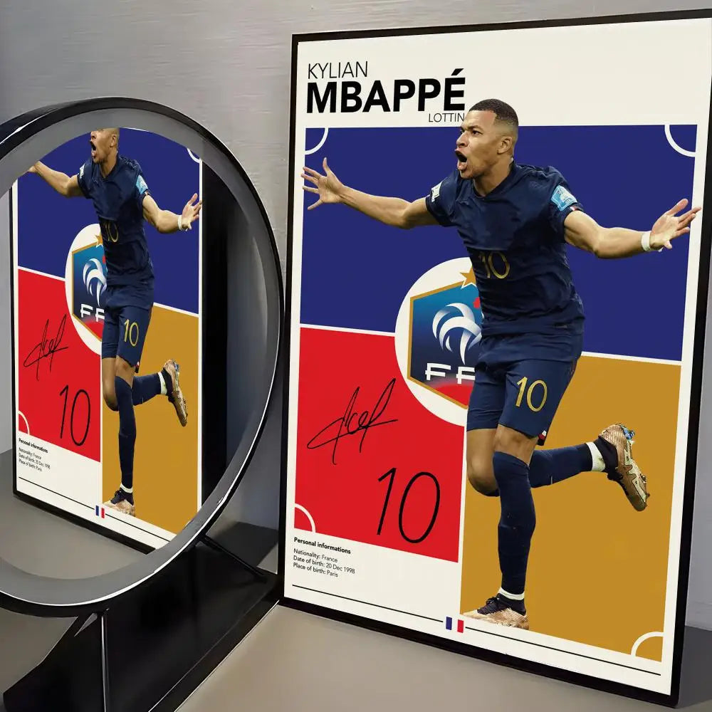 A framed poster featuring Kylian Mbappé in a dark blue soccer uniform celebrating, set against a blue background.
