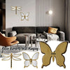 A set of resin butterfly wall hangings featuring antique gold frames and mirrored wings.