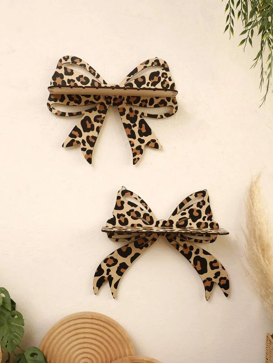 A leopard print bow-shaped wall mounted storage rack made of natural wood.