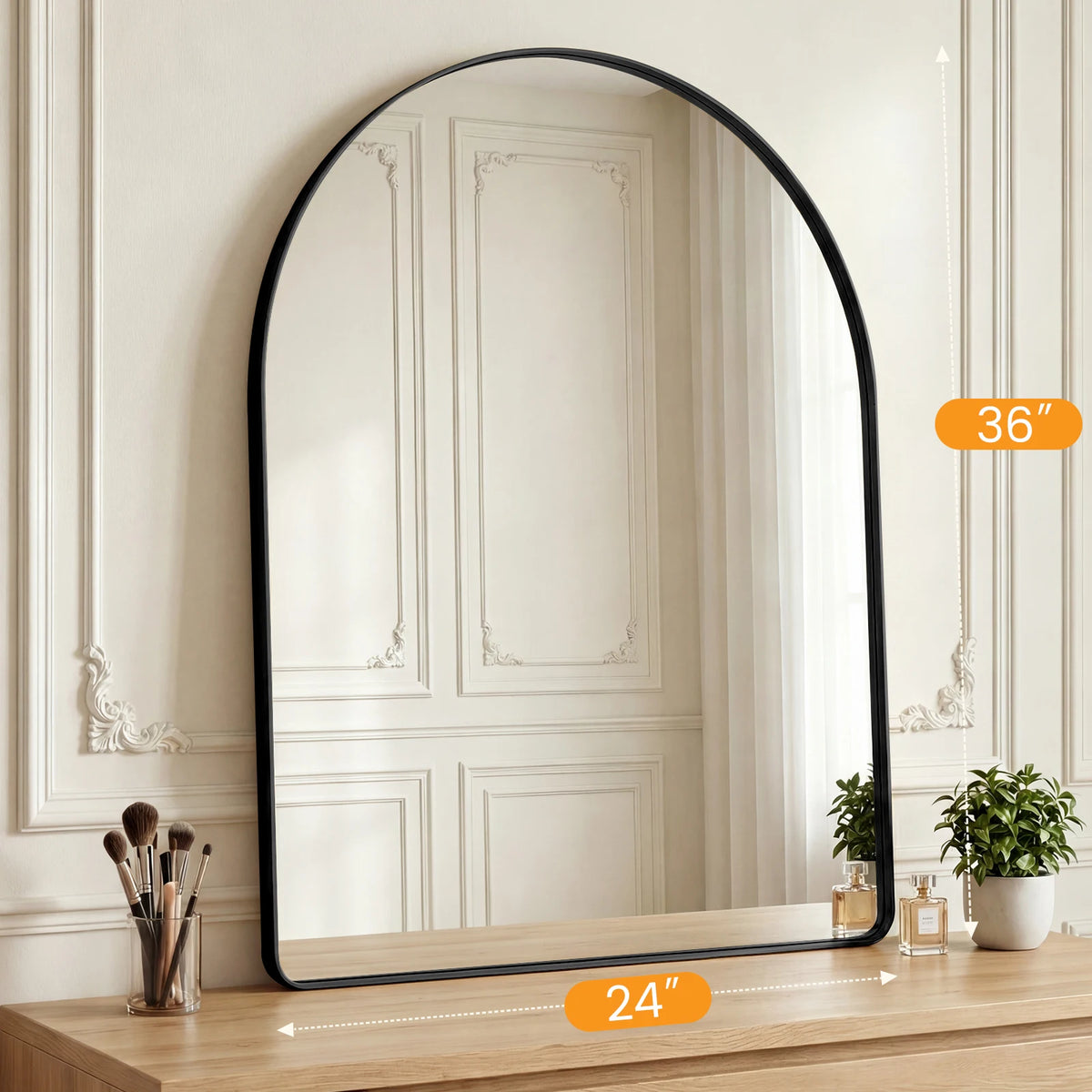 An arched full-length wall mirror with a matte black frame reflecting a room interior.