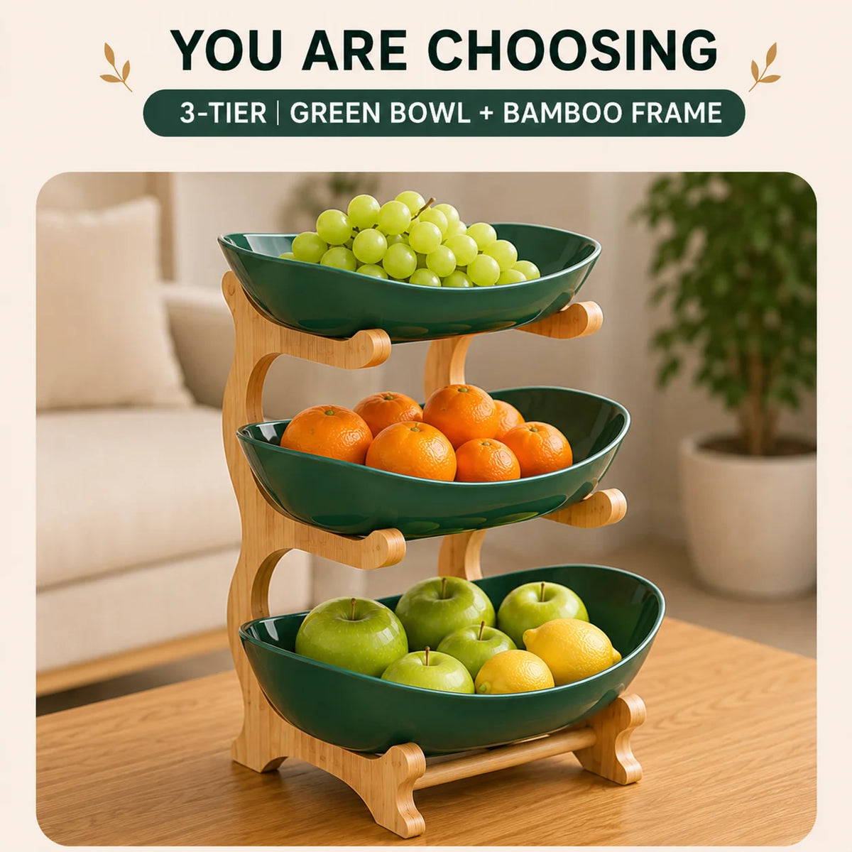 A 3-tier green bowl and bamboo frame fruit basket stand filled with green grapes, oranges, and apples.