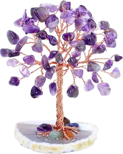 A crystal money tree decor featuring purple amethyst crystals on a wooden branch and a light stone base.