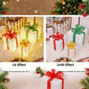 Set of three white LED light-up Christmas gift boxes with red ribbon and green accents