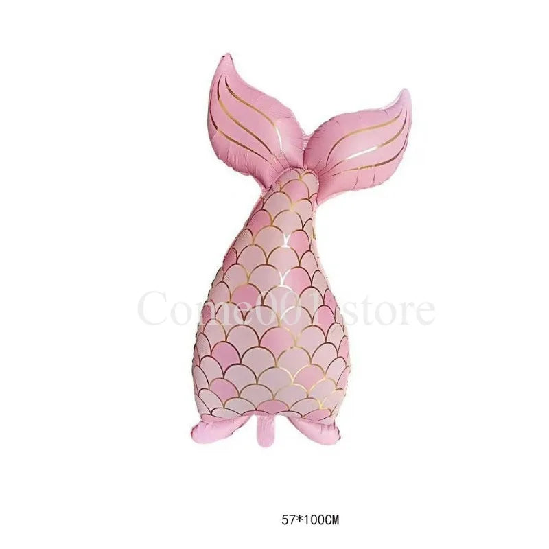 Pink mermaid tail foil balloon decoration with a dolphin fin shape