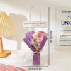 A handmade crochet flower bouquet wrapped in purple paper and presented in a clear cellophane bag.