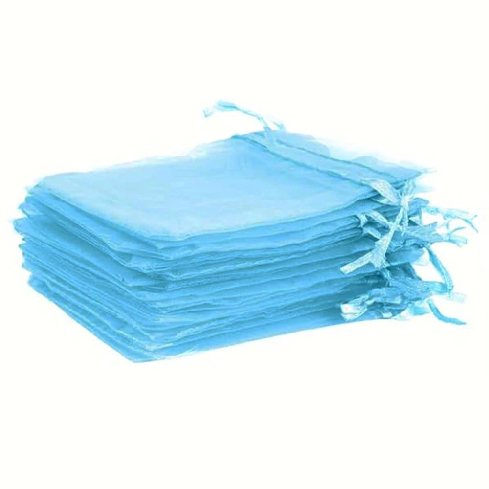 A stack of light blue organza bags with white and gold drawstrings.