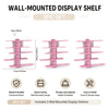 A set of three pink wall-mounted display shelves for home decor and storage.