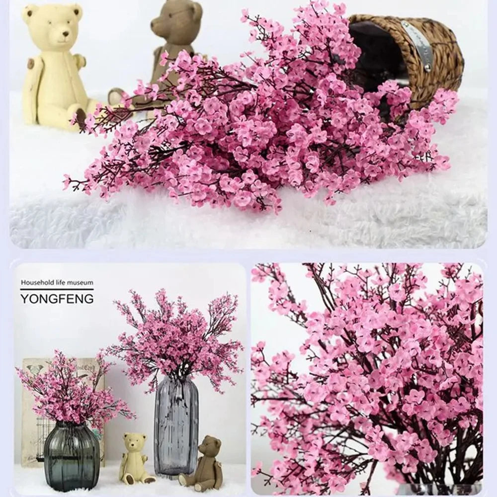 A bouquet of pink cherry blossoms and gypsophila artificial flowers displayed in a vase.