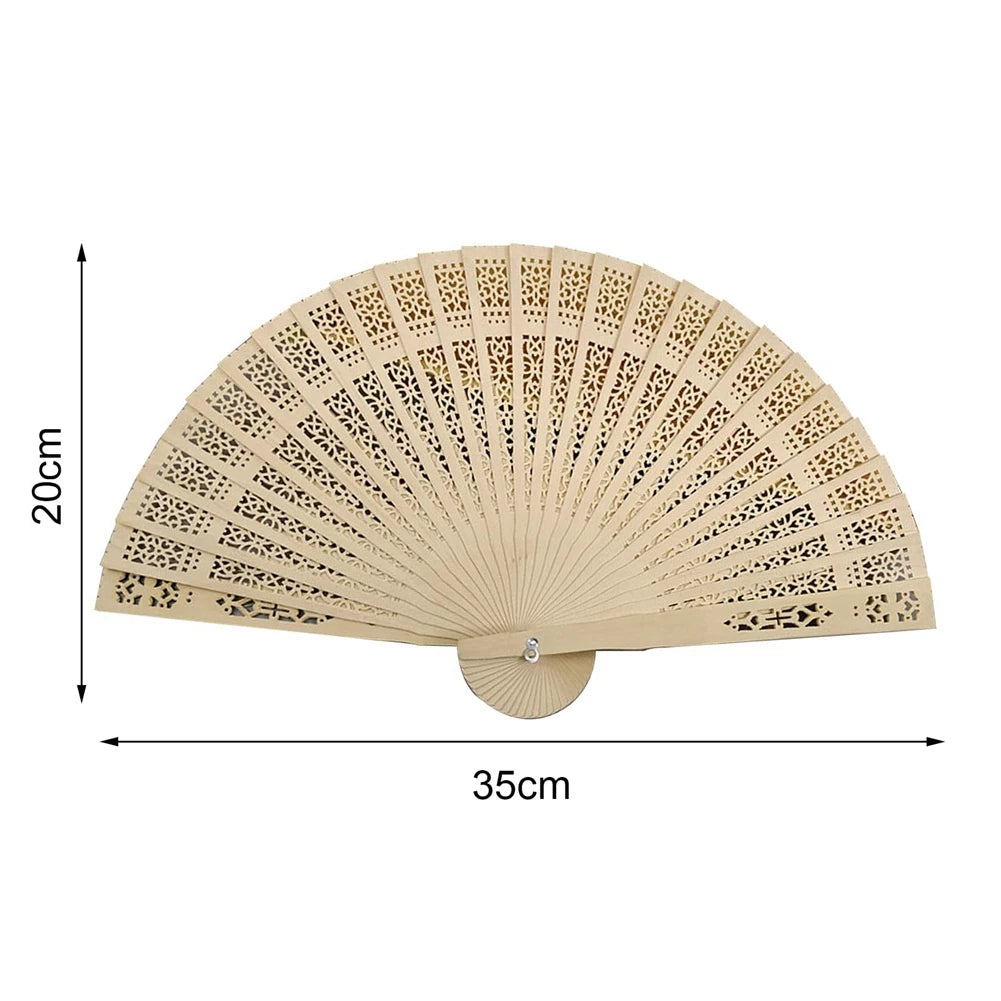 A light beige vintage wooden folding hand fan with intricate cutouts, shown flat.