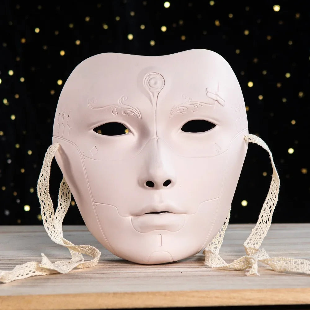 A pale pink ancient style masquerade mask with delicate lines resting on a wooden surface.