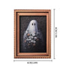 A framed picture featuring a white ghost surrounded by small flowers and foliage.