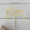 Elegant gold acrylic birthday cake topper with happy birthday lettering on a stick