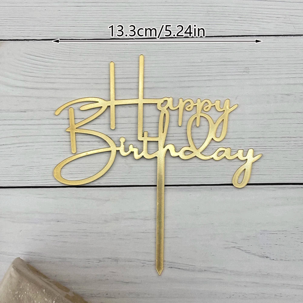 Elegant gold acrylic birthday cake topper with happy birthday lettering on a stick