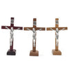 A set of three handcrafted wooden crucifixes with stands depicting Jesus Christ.