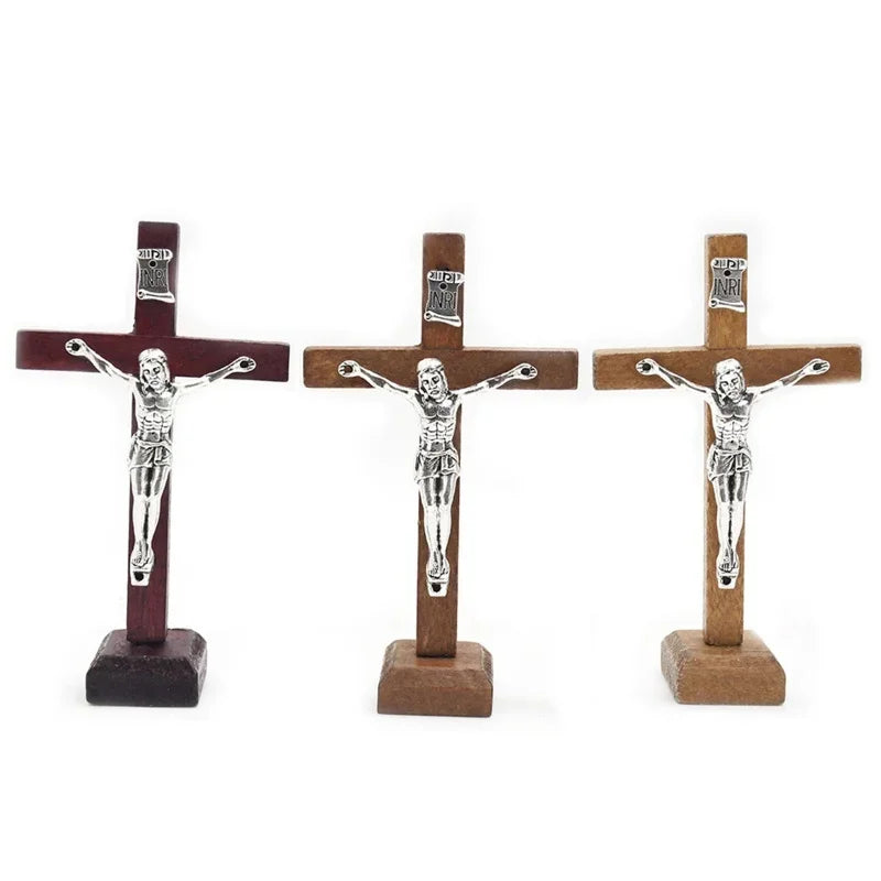 A set of three handcrafted wooden crucifixes with stands depicting Jesus Christ.